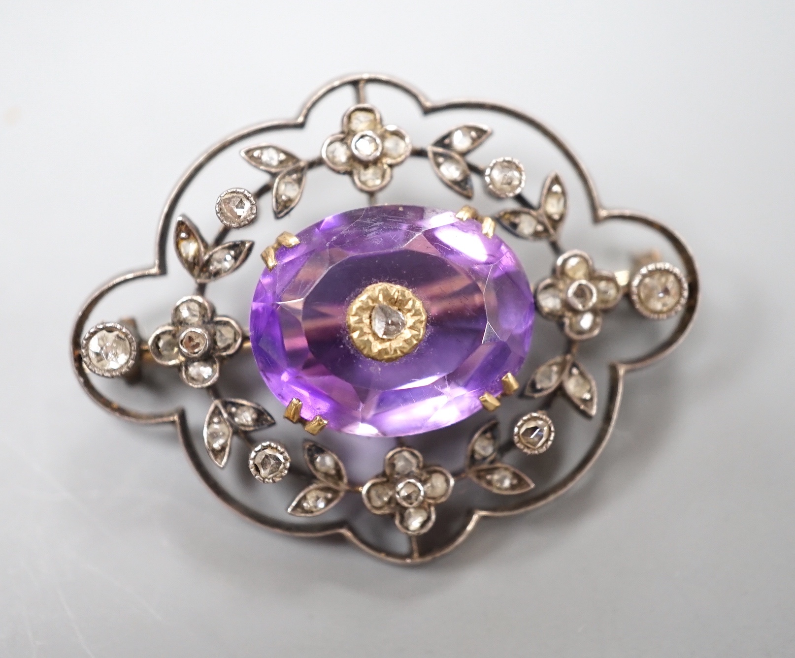 An Edwardian yellow metal, amethyst and rose cut diamond set shaped oval brooch, 34mm, gross weight 5.9 grams.